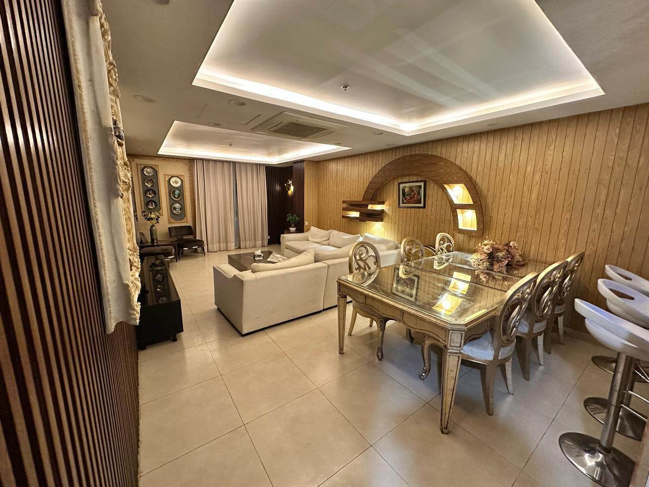 Open-plan lounge and dining area with upholstered chairs and a dining table