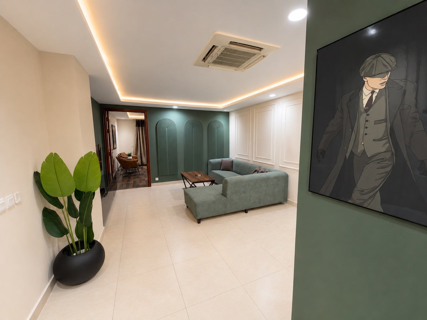 Lounge with portrait artwork and a decorative plant