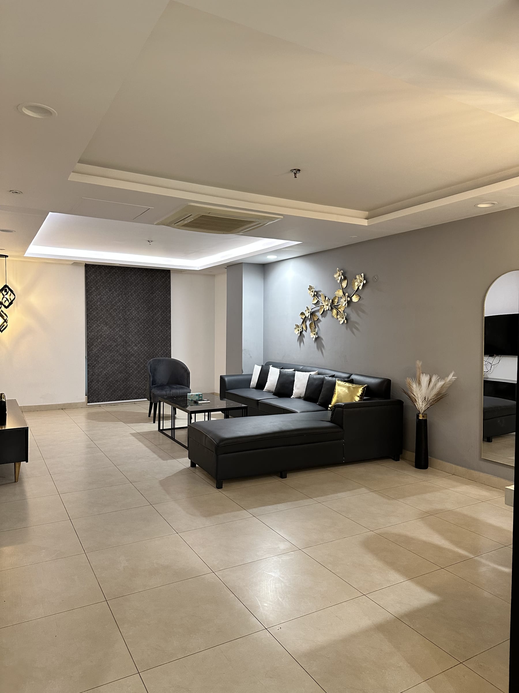 Living area with a sectional sofa, armchairs and coffee table
