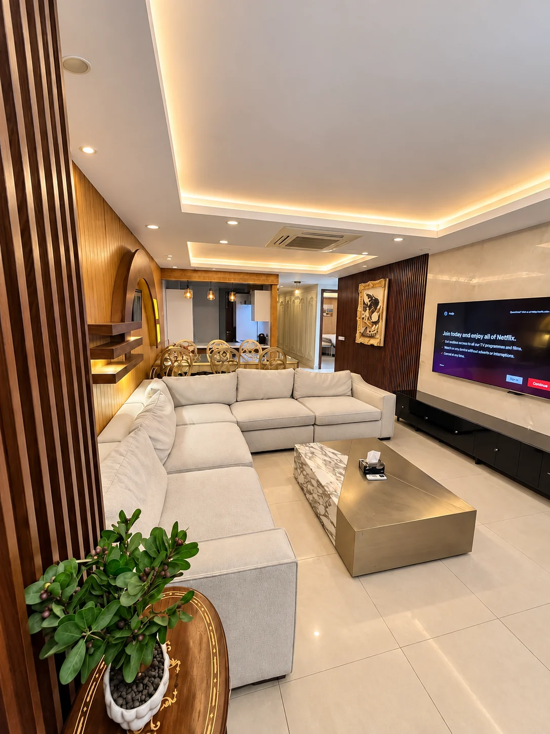 Living room with cream seating, a gold-toned coffee table and recessed lighting